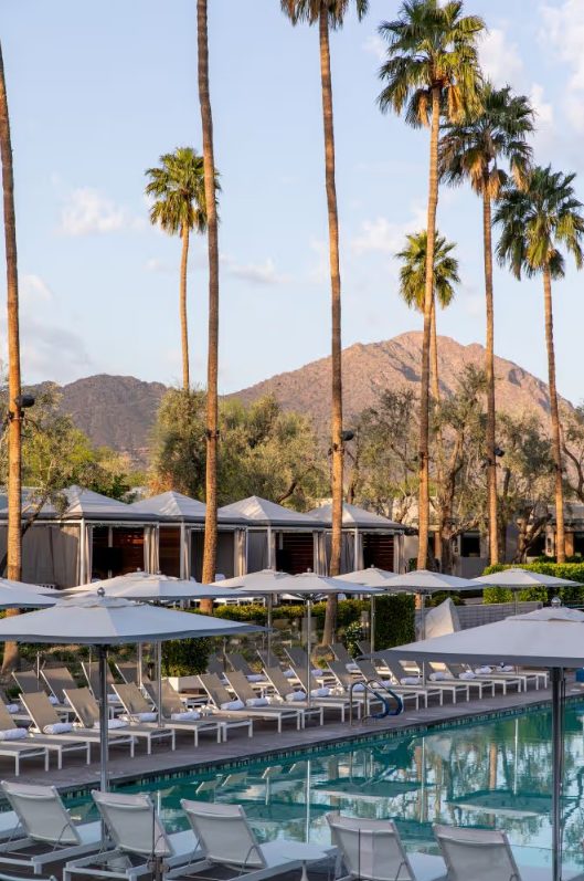 Resort pool with cabanas and mountain views